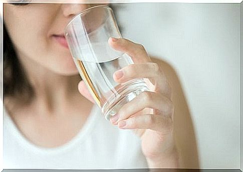 A woman drinking a glass of water