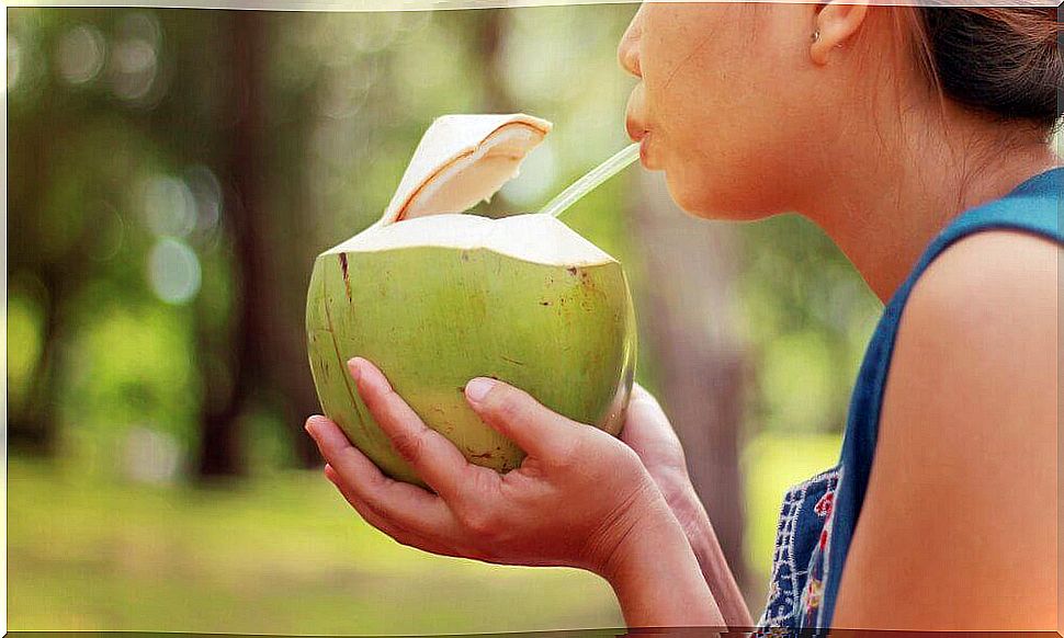 Drinking coconut water.