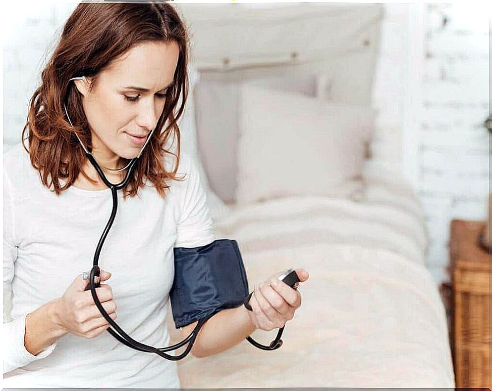 Woman taking blood pressure.