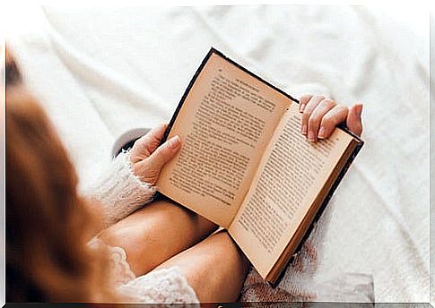 The woman is reading the book