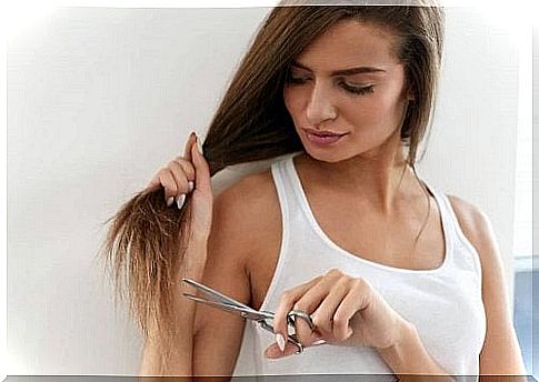 The woman cuts the damaged ends