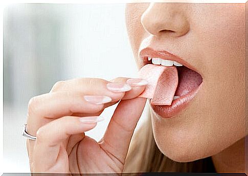 chewing gum on an empty stomach - a woman putting gum in her mouth