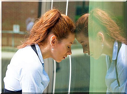 the woman is leaning her head against the wall and feeling guilty