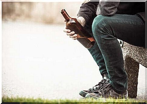 A man holding a bottle of alcohol - fighting alcoholism