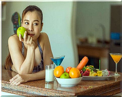 Pensive woman at the table with fruit