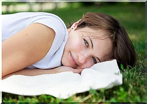 joy and happiness woman lying on the pillow smiling