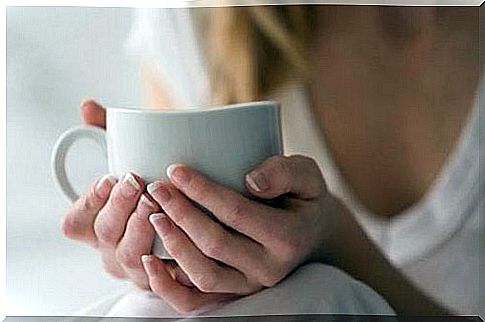 A cup with an infusion in your hands