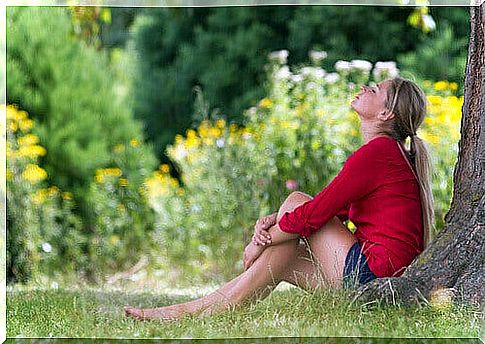 Woman resting under the tree in the meadow good sleep fresh air