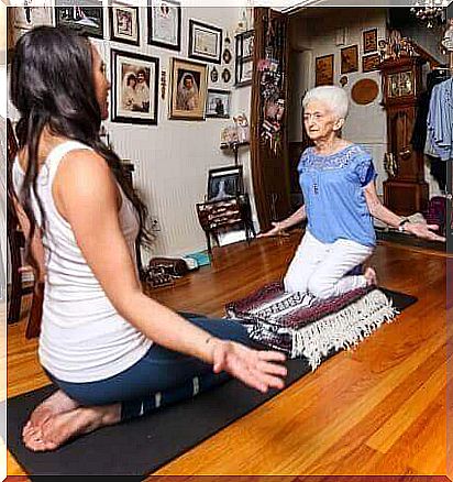 yoga - elderly woman with a trainer